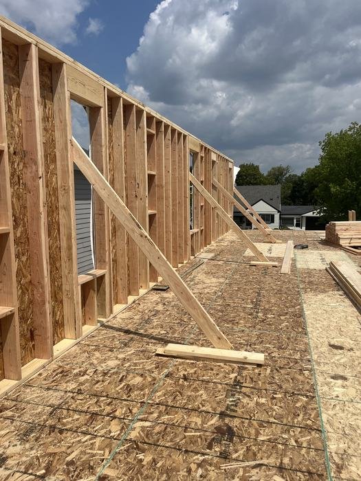 Exterior wall framing standing on the first floor deck of a new home build