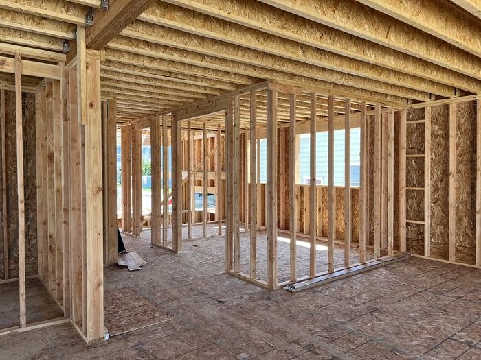 Interior partition walls framed out to define rooms and doorways on the main floor